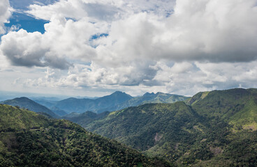 Hill range with white cloud and green forests