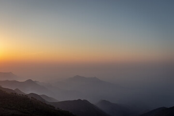 mountain range sunrise at dawn with mist from flat angle
