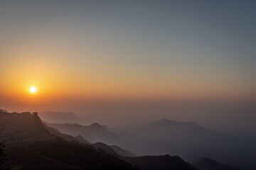 mountain range sunrise at dawn with mist from flat angle