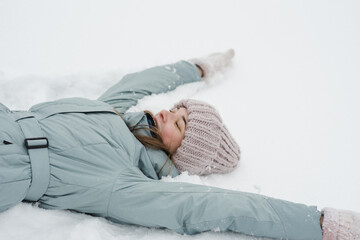 Woman are lying in the snow in winter