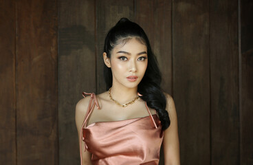 Fototapeta premium elegant sensual young woman in brown dress on recamier outdoor shot