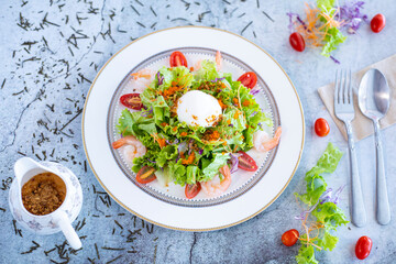 Salad with vegetables and poached eggs