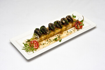 Plate of Provençal snails, on bread bathed in butter sauce with shallot with garlic and herbs