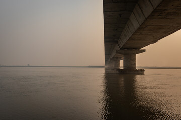 road bridge over river with its water reflection at dawn from low angle