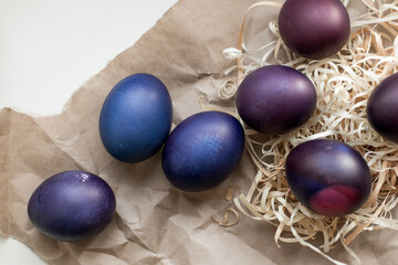 Painted blue and purple Easter eggs on a textured background. Easter eggs on a plate.