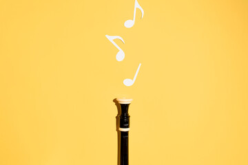 Musical flute and notes, flat lay on a yellow background. Copy space