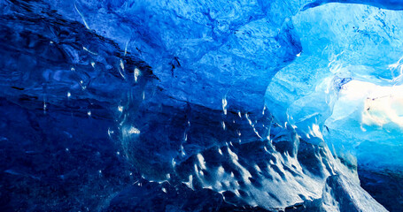 Glacial Ice Cave, Svinafellsjokull glacier, Skaftafell National Park, Iceland. Abstract ice background. Blue background with cracks on the ice surface.