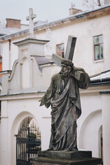 Fototapeta na wymiar Statue, sculpture of Jesus Christ carrying the cross. Armenian Catholic Church in Lviv, Ukraine. Ancient architecture of Eastern Europe.