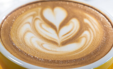 Latte art and yellow cup