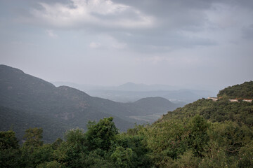 Mountain range with green forests and blue sky