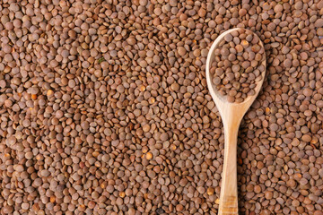 Natural organic dry brown lentils for a healthy diet. background texture