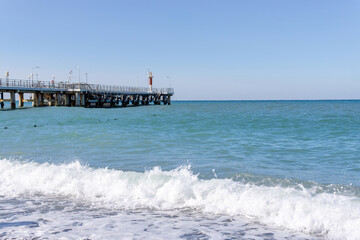 Pebbles on the beach close up on the sea surf background, copy space.