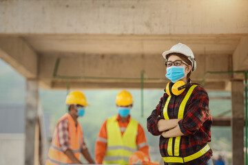 Corona or Covid-19 wear masks during the design of construction. New normal.Industrial engineering team wears a COVID 19 protective mask. Workers wear a quarantine face mask.