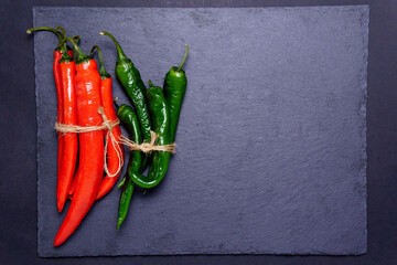 Red green pepper on black background. Food concept. Top view. Vegetable menu.
