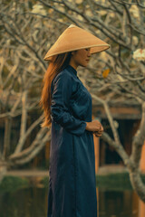 Fototapeta premium Beautiful Vietnam girl from Hue city, Vietnam who wearing Ao dai. Ao dai is famous traditional custume for woman in Vietnam. Vintage style,travel and relaxing concept.