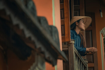 Beautiful Vietnam girl from Hue city, Vietnam who wearing Ao dai. Ao dai is famous traditional custume for woman in Vietnam. Vintage style,travel and relaxing concept.