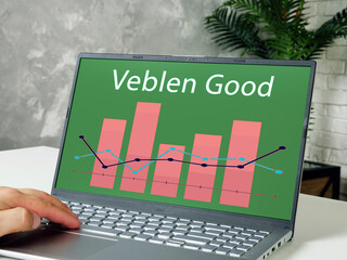  Financial concept meaning Veblen Good with phrase on the piece of paper.
