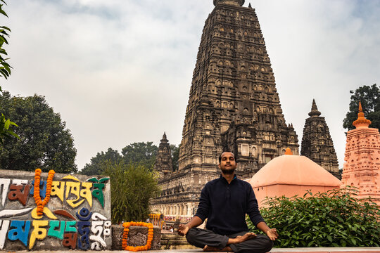 man devotee meditating for almighty god with temple background