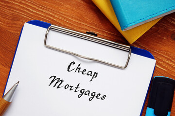 Financial concept meaning Cheap Mortgages with phrase on the piece of paper.