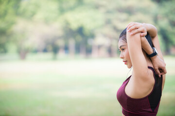 Asian woman is warm up, To make the muscles flexible Before going to jogging for good health and energy
metabolism,Outdoors cross training workout. Healthcare concept