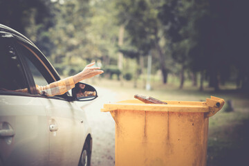 Woman hand picking up garbage plastic and Glass bottles for cleaning at park