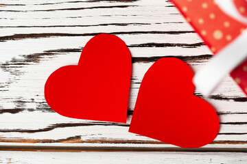 Red paper hearts on wooden background close up