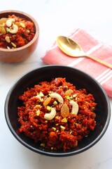 Gajar Halwa. Indian carrot pudding. It's a sweet dessert made from carrots, sugar, and cream. Garnished with cashew, almond, Raisin, and pistachio.