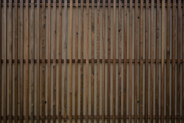 Modern wooden facade made of wood planks mounted vertically next to another.
