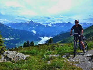 Fototapeta na wymiar Austrian Alps-cyclist and outlook on the Alps from Zillertaler road