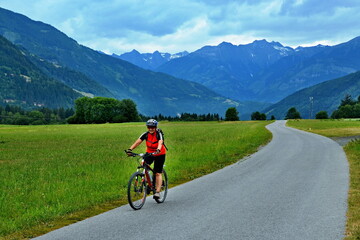 Fototapeta premium Austrian Alps - cyclist on the cycle path not far Lind im Drautal
