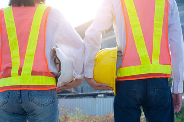 Close up businesspeople holding hard hat outdoor on site building construction