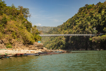 lake transparent water surrendered with mountain forest and fishing boats