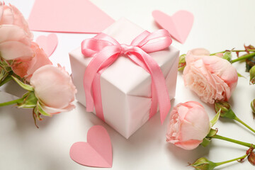 Envelope, roses, hearts and gift box on white background