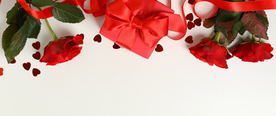 Concept of Valentine's day with roses and gift box on white background