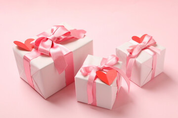 Gift boxes with with decorative hearts on pink background