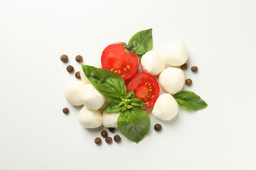 Mozzarella, basil, tomato and pepper on white background, top view