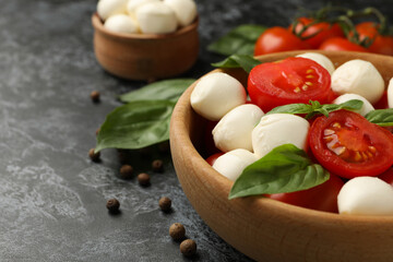 Concept of tasty eating with mozzarella cheese on black smokey background, space for text