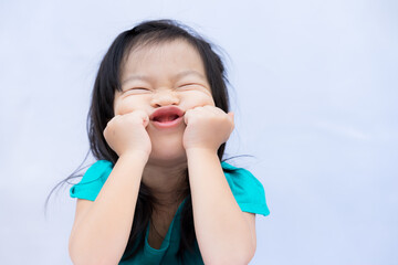 Child make funny faces. Kids puts his hands, feet and chin and does freaky face. Cute baby good...