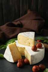 Concept of tasty eating with camembert and hazelnut on tray
