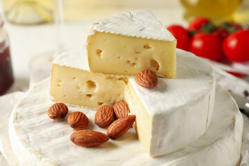 Concept of tasty eating with camembert and hazelnut, close up