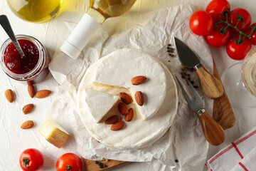 Concept of tasty eating with camembert on white table, top view