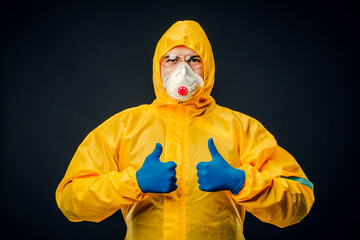 A man in a protective suit on a black background. Protection against virus outbreaks