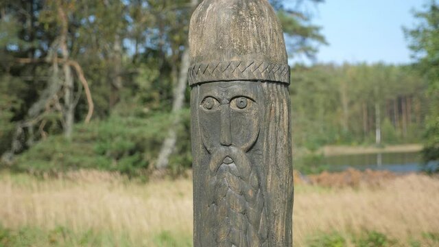 An old wooden statue of Slavic culture stands. God of thunder in mythology.