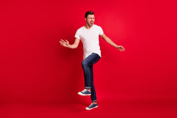 Full length photo of astonished young man look empty space open mouth isolated on burgundy color background