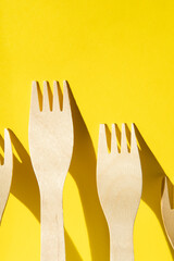 Wooden zero waste forks on a yellow background