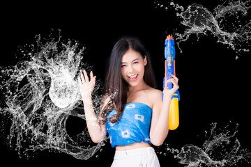 Portrait cheerful young asian woman Wearing a yellow tank top ,holding plastic water gun Smiling and having fun playing in the water Songkran festival, Songkran Thailand. isolated on black background.