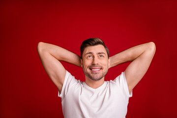 Fototapeta na wymiar Photo portrait of dreamy male worker relaxing looking up at blank space imagine smiling isolated vivid red color background