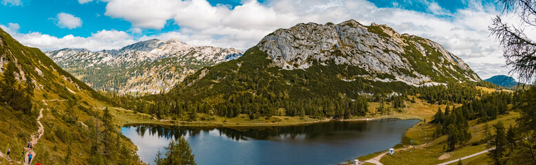 Naklejka na ściany i meble High resolution stitched panorama of a beautiful alpine summer view with reflections in a lake at the famous Tauplitzalm, Salzkammergut, Steiermark, Austria