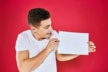 man holding white sheet copy space office close-up red background