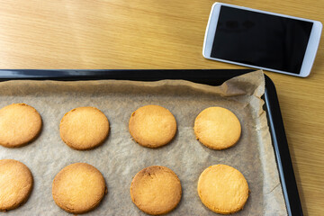 スマートフォンを見てクッキーを作るイメージ